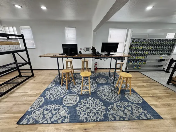 The A2Z counter: a long wooden counter with two computers and stools, the Gleam mixing bank to the right